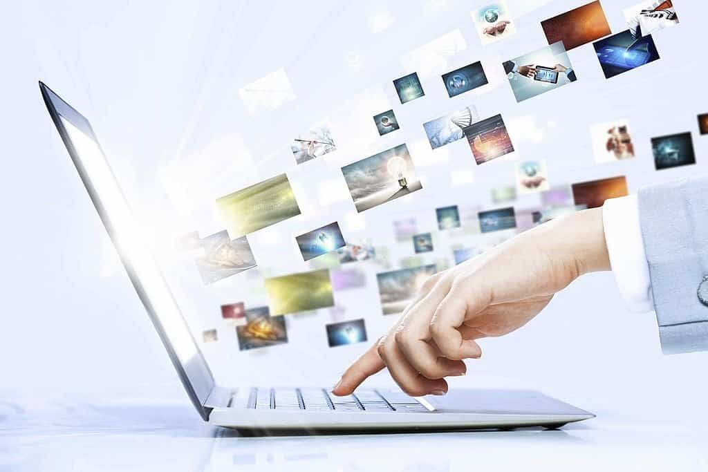 Close up image of laptop and human hands typing on keyboard